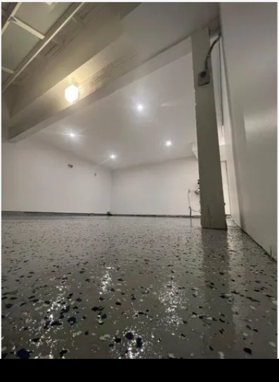 Finished garage interior with epoxy floor and lighting